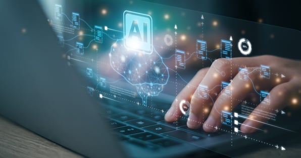 laptop with hands and AI icon